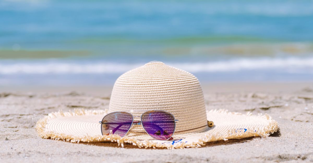 Sun hat and sunglasses on a sunny beach