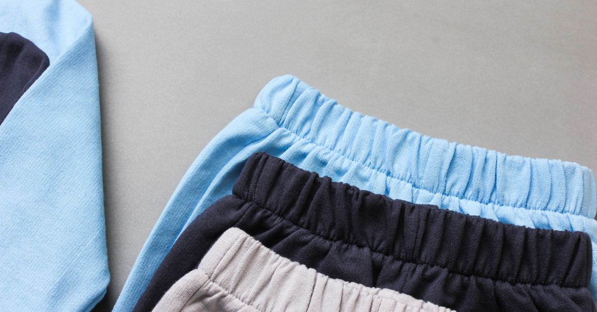 Folded kids' clothing in soft colors